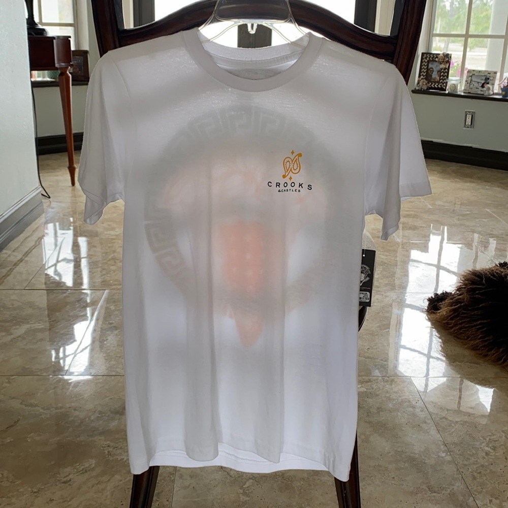 T-Shirt is a size small never worn, white with a design on the back.